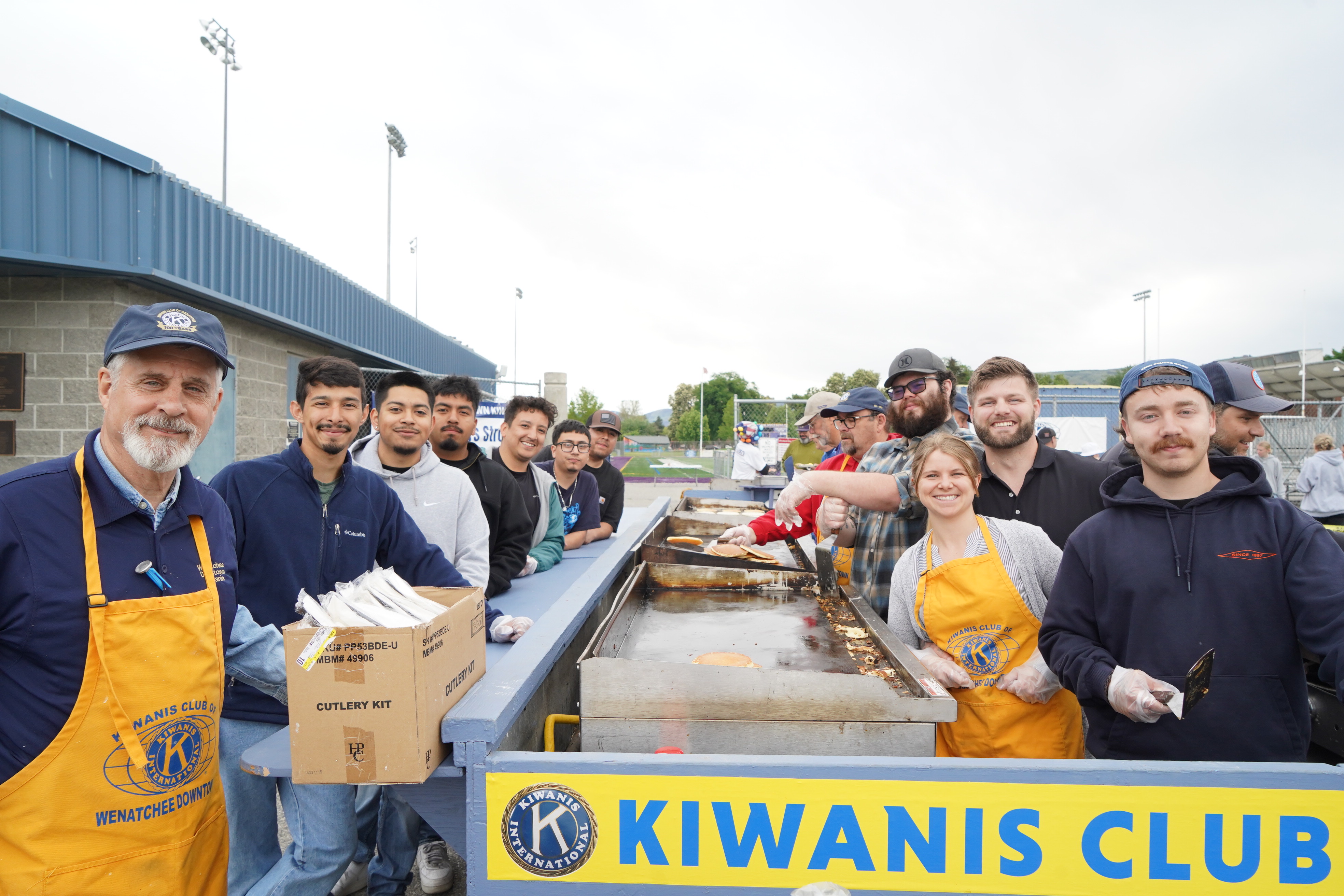Photograph of students volunteering at the Kiwanis Pancake Breakfast before the Apple Blossom Grand Parade