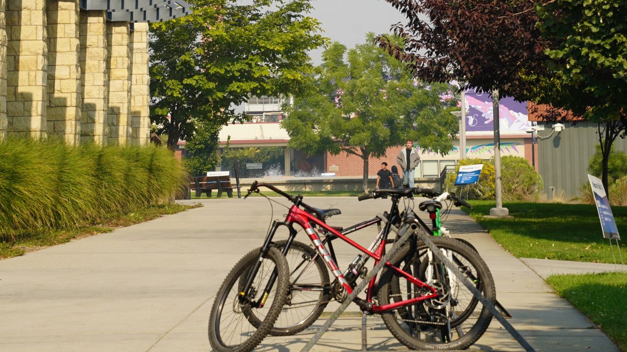 Bicycles tethered to a bike parking spot outside of Wenatchi Hall