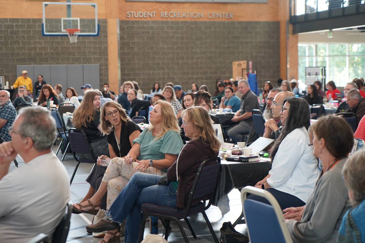 Faculty and staff sitting at tables for Launch Week 2025