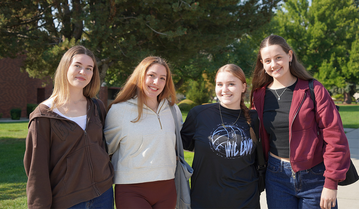 Four WVC students stand together and smile at the camera.
