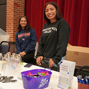 The Student Benefits Navigator stands at a table at a student resource fair.