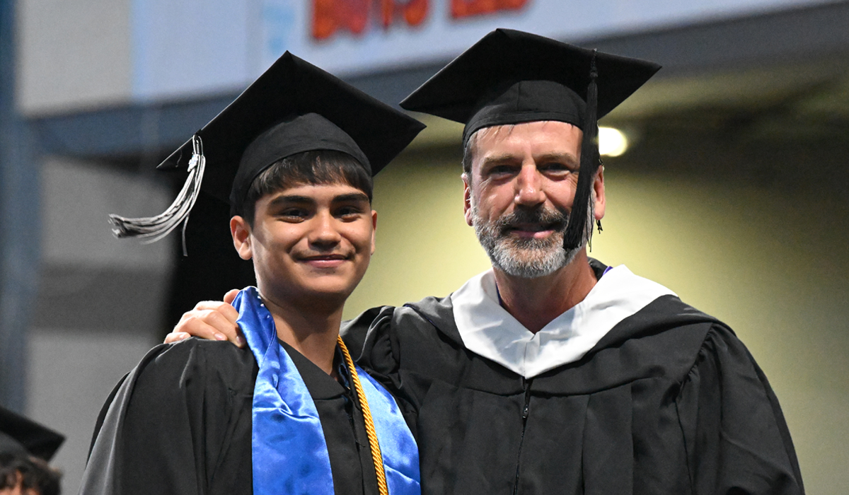 English faculty, Derek Sheffield, with graduate student at 2026 graduation ceremony.