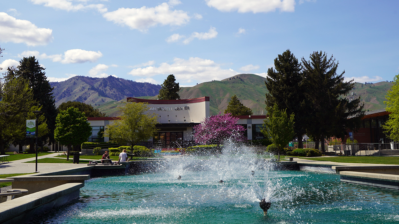 A view of the Van Tassell Center entrance through the campus fountain