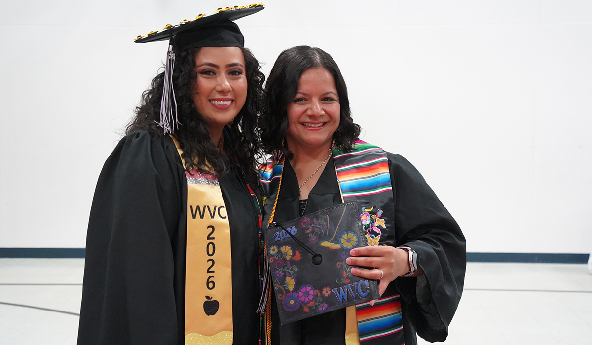 Two WVC Omak graduates smile at the camera.