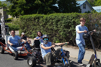 The Mechatronics Club members ride their go-karts at the Apple Blossom Parade.
