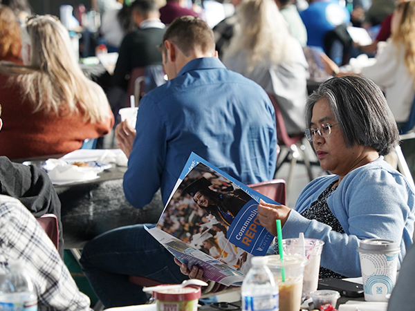 WVC Professor Sompheng Batch reads the WVC Community Report at a meeting.