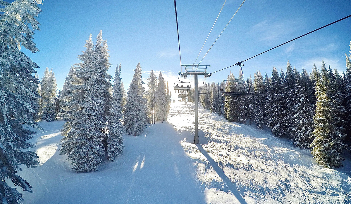 Uphill view of a ski lift on a snowy mountain