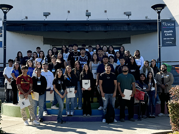 A group of CAMP students and staff stand on the steps of Van Tassell Center