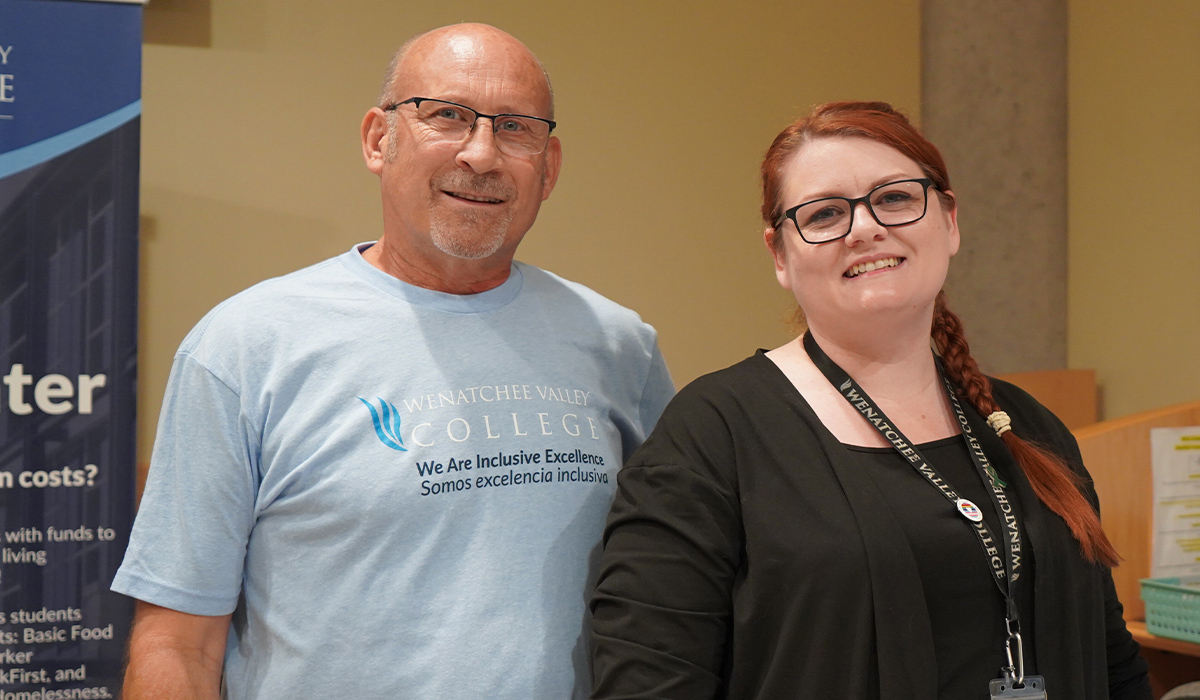 The Student Access Services director and program assistant stand together in the Wenatchi Hall registration lobby.